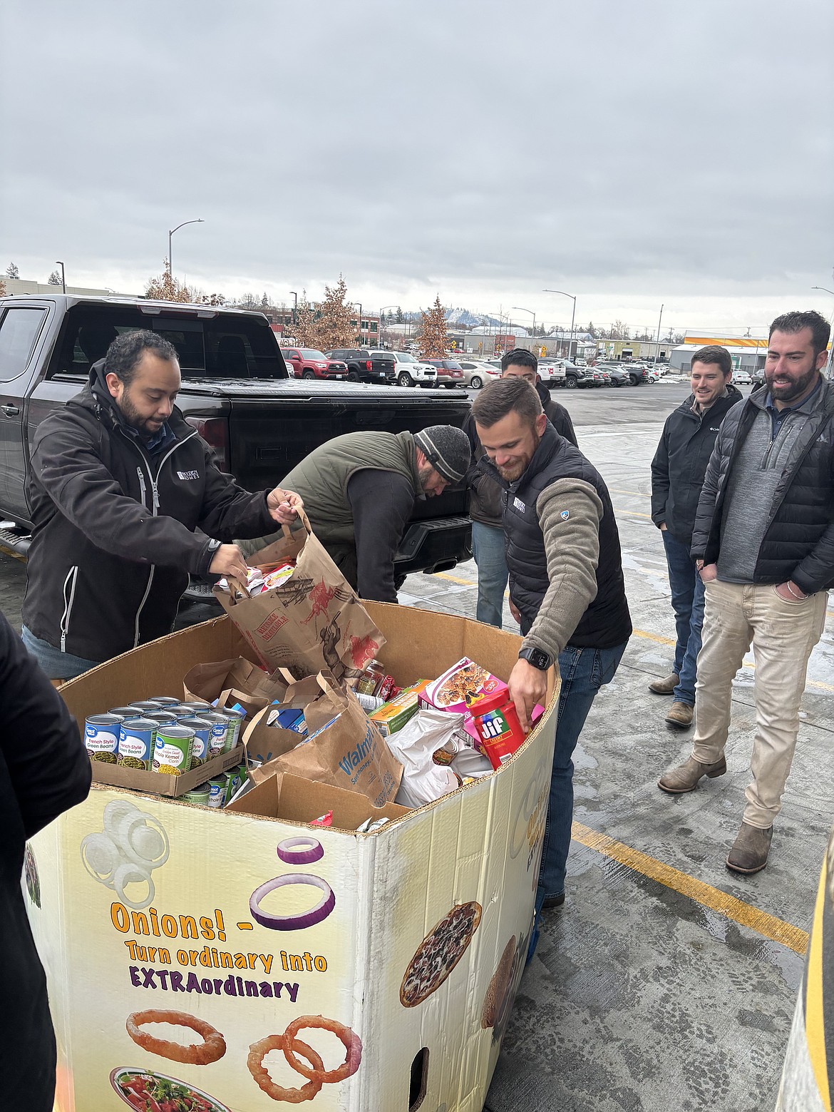Hayden Homes team members unload boxes of non-perishable food for Second Harvest in Spokane. Second Harvest supplies many of the food banks in Grant and Adams counties, and brings mobile food distributions to outlying communities in the Basin.