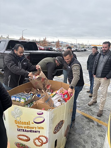 Hayden Homes team members unload boxes of non-perishable food for Second Harvest in Spokane. Second Harvest supplies many of the food banks in Grant and Adams counties, and brings mobile food distributions to outlying communities in the Basin.