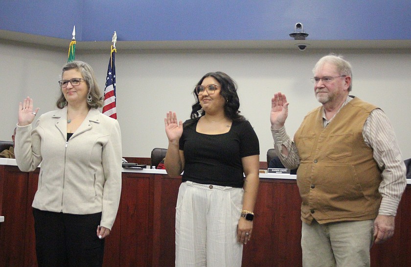 From left, new Othello City Council members Kelli Camp and Alma Carmona and new Mayor Ken Johnson are sworn in at the Othello City Council meeting Monday.