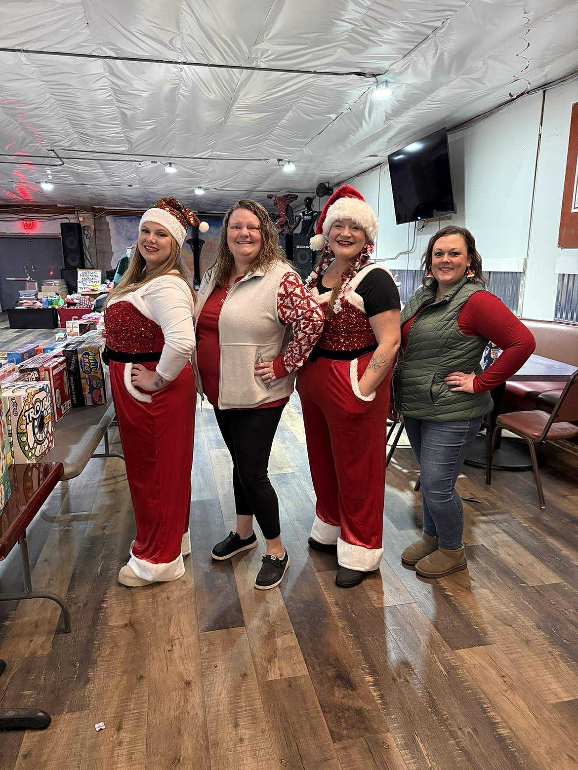 The admins of Moms Helping Moms of Grant County WA pose for a photo during the groups recent gift give-away. From left to right: Jeannie Austin, Stephanie Blaueret, Ryan Hawn and Sarah Kluge.