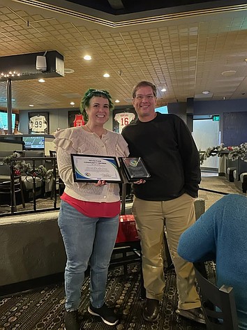 Sarah Delacruz, left, of Moses Lake, receives the Kevin Fuhr Community Member of the Year Award Dec. 18 from Moses Lake Community Coalition committee member Matthew Paluch. Delacruz was chosen, Paluch said, for her tireless advocacy for the Moses Lake Public Library and its programs.
