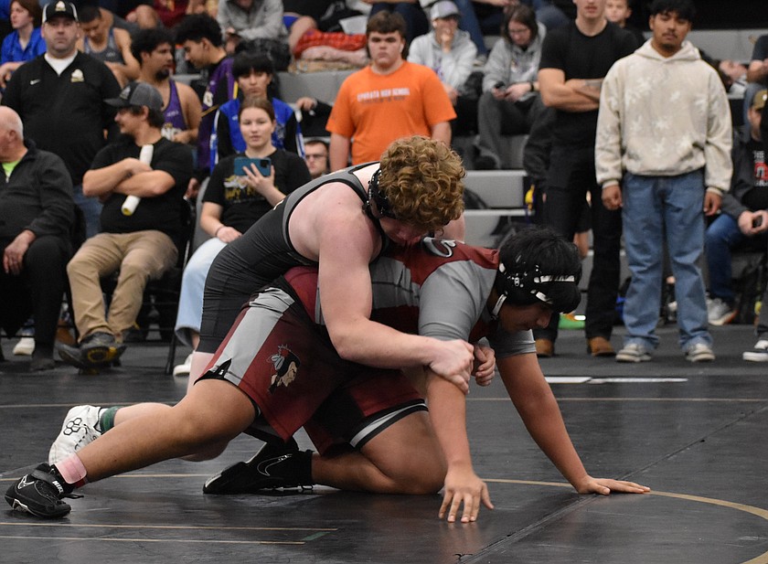 Krew Jenks from the Knights prepares to put Emmanuel Alonso from the Wahluke Warriors on the mat during the first round of matches at Saturday’s tournament. The Knights would place the highest of the basin teams to take second overall.