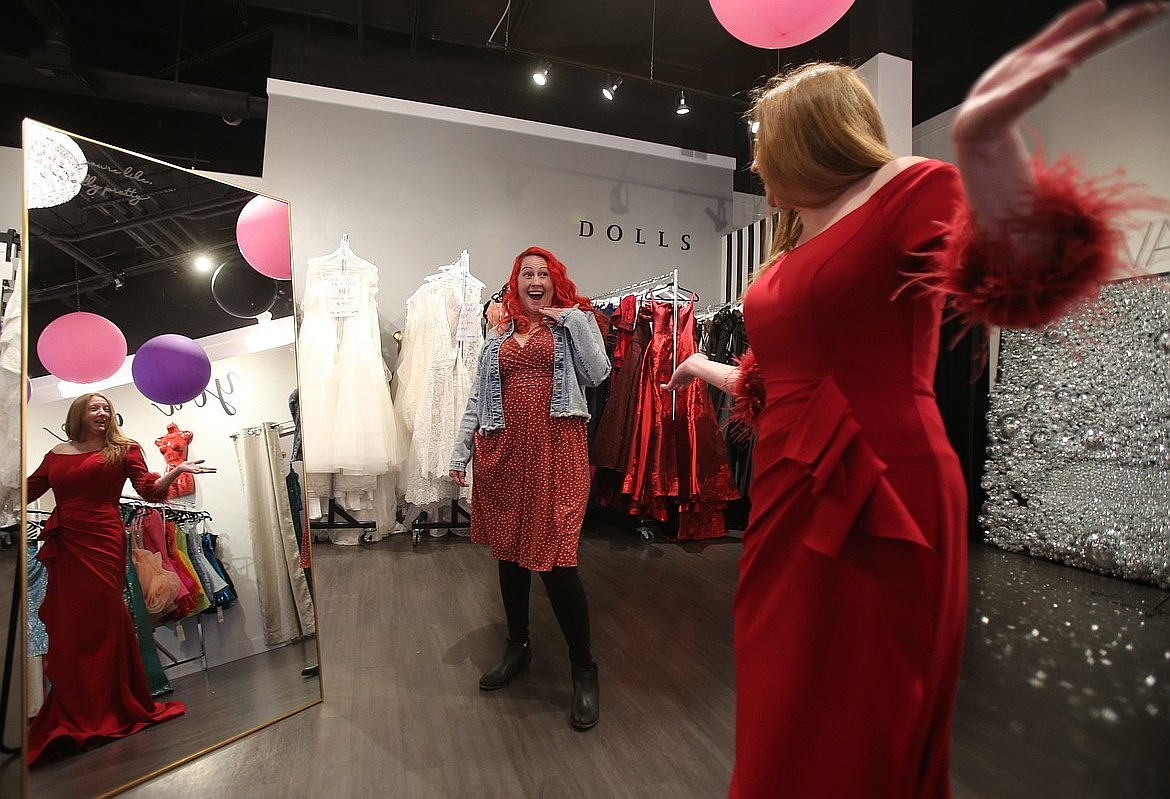 Doree Handford reacts as Sheila Holfeltz sashays out of the dressing room in a red gown on a March afternoon at The Dress Shop in Coeur d'Alene in preparation for Mom Prom, which was held April 12.