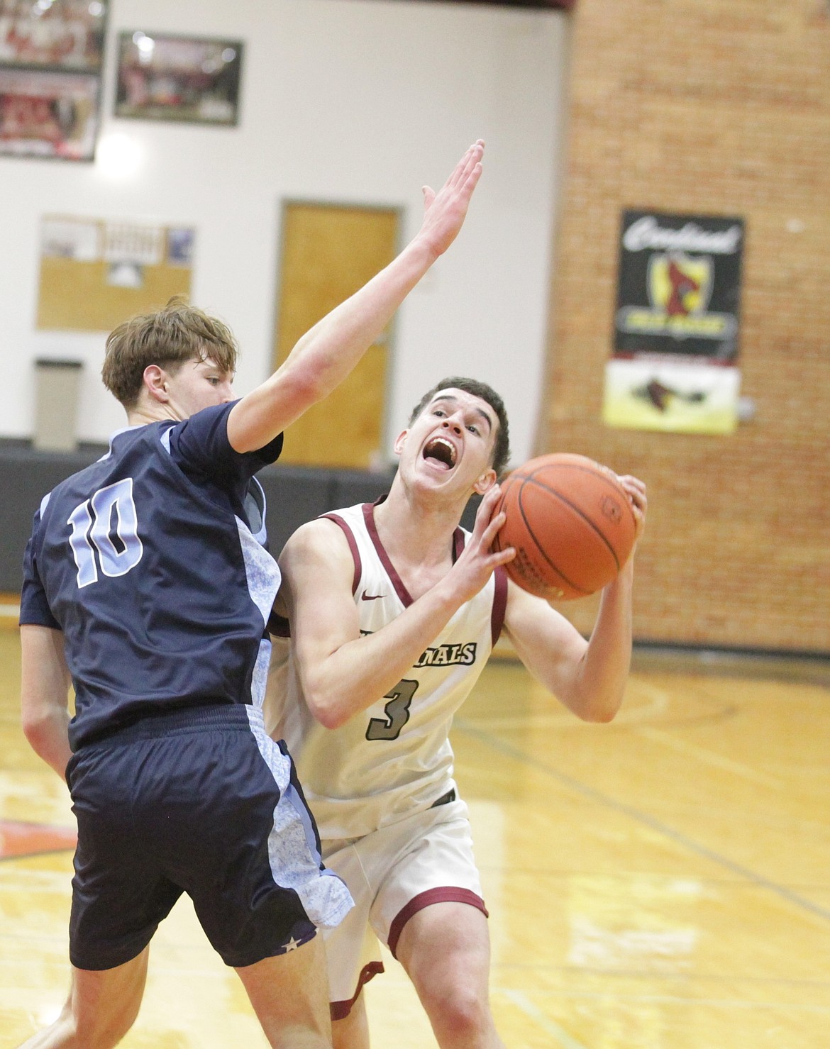 JASON ELLIOTT/Press
North Idaho College freshman guard Ace Arnold attempts to shoot over Spokane College's Grant Olsen during the first half of Monday's game at Rolly Williams Court.