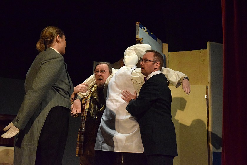 Colonel Mustard (Dave Stearns) left, and Professor Plum (Justin Martin) hold the dead body of the cook while talking with Wadsworth (Rebecca Grommesh) in the Masquers Theater production of the mystery-comedy “Clue! On Stage” in February.