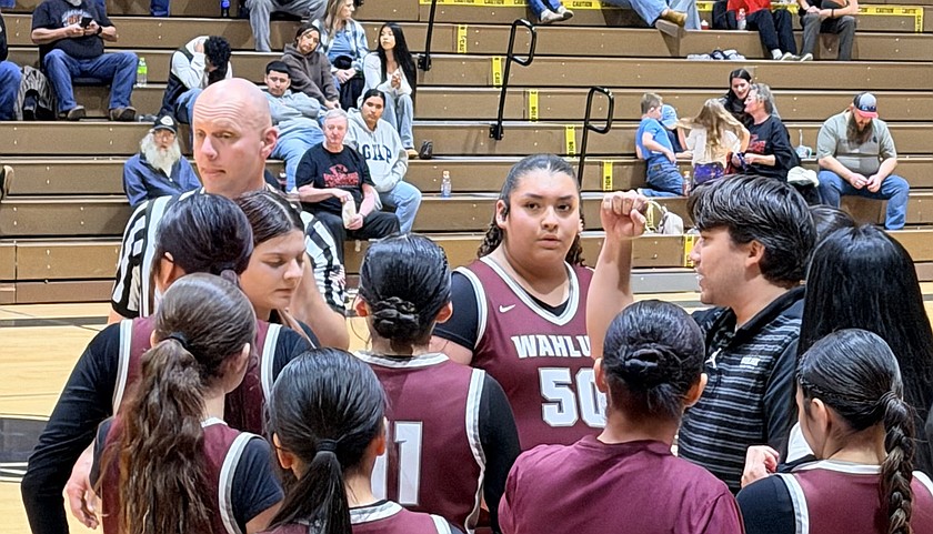 The Wahluke Warriors gather around Head Coach Mikai Hirai during a timeout in their victory over River View Monday evening. Hirai said this was an exciting achievement for the team as they earned their first victory in two years.