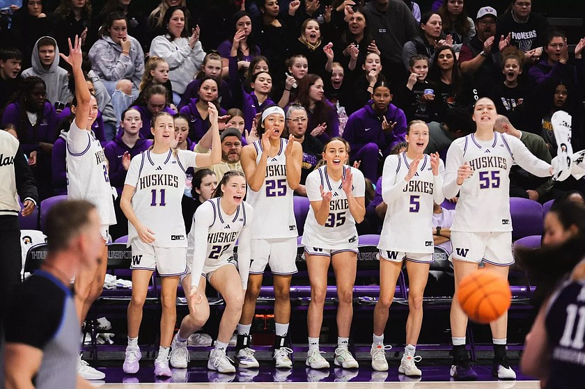 UW’s sideline erupts in cheers during the Huskies victory over Northwestern Monday. The Huskies will be back on the court New Year’s Day to face Michigan.
