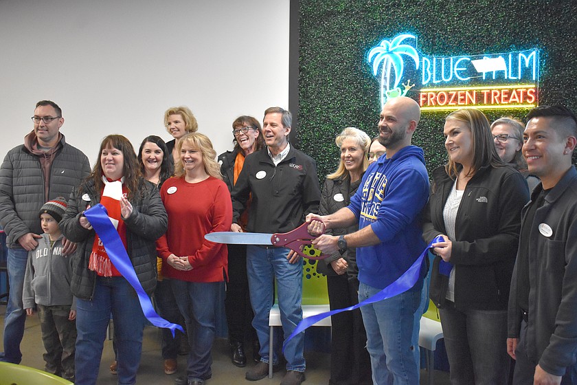 Cody Hall cuts the ceremonial ribbon at Blue Palm Frozen Treats in Moses Lake in February. Hall, who bought Blue Palm in 2020, remodeled the building completely and added ice cream to go with Blue Palm’s signature frozen yogurt.