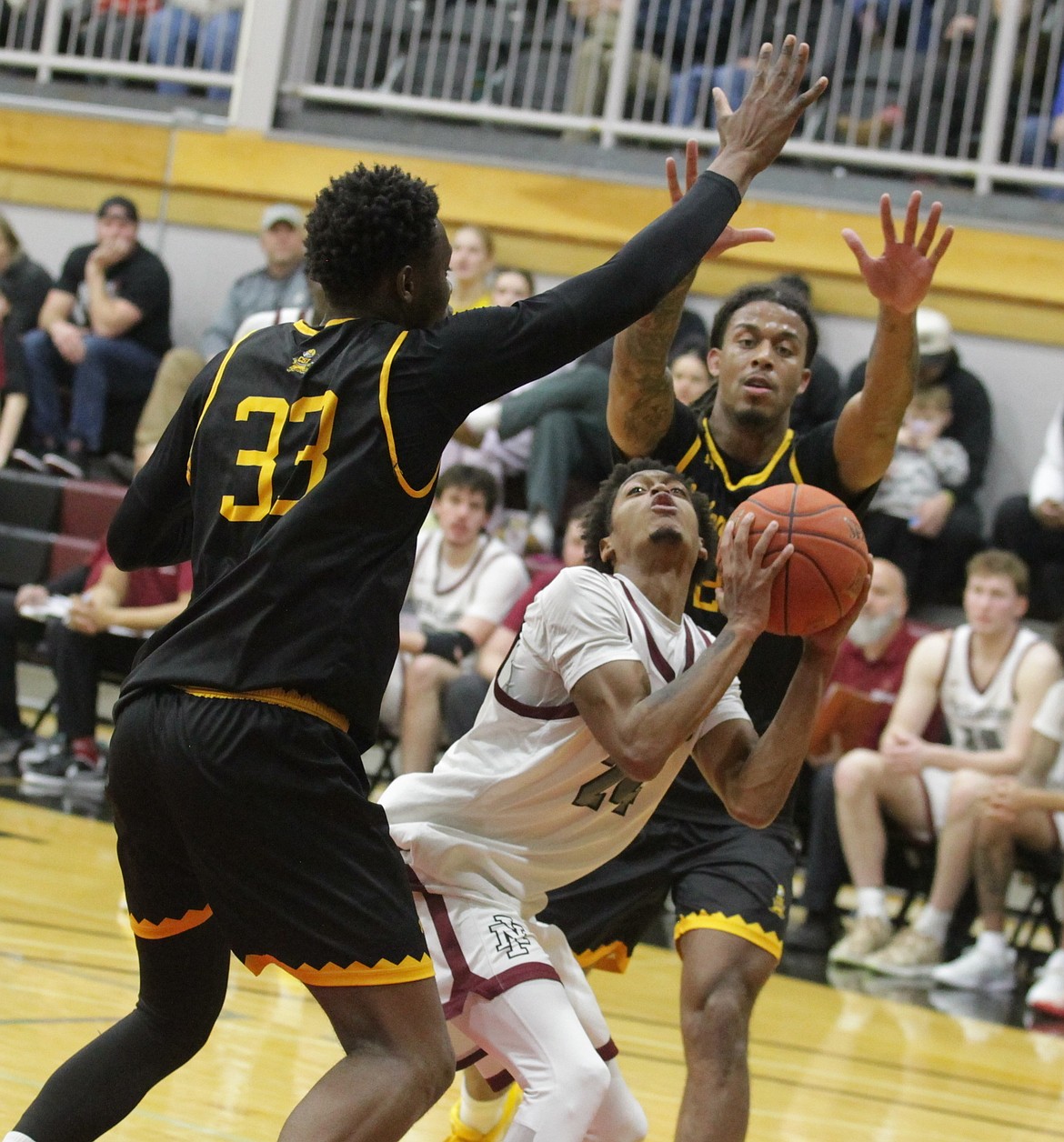 JASON ELLIOTT/Press
North Idaho College freshman guard Justus Haseley attempts a shot in between College of Southern Idaho defenders Guygustone Kasenga (33) and Nathan Ahner (22) during the second half of Saturday's game at Rolly Williams Court.