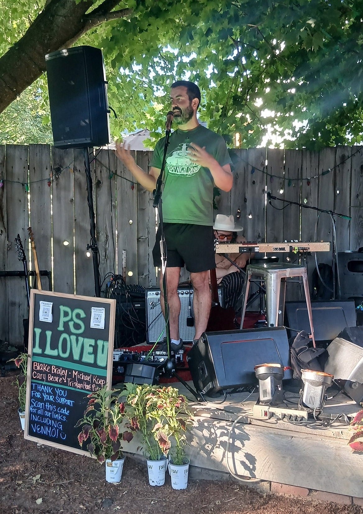 Adam Schluter speaks at a past Monday Night Dinner, a biweekly event that brings together people in his backyard from spring to fall.