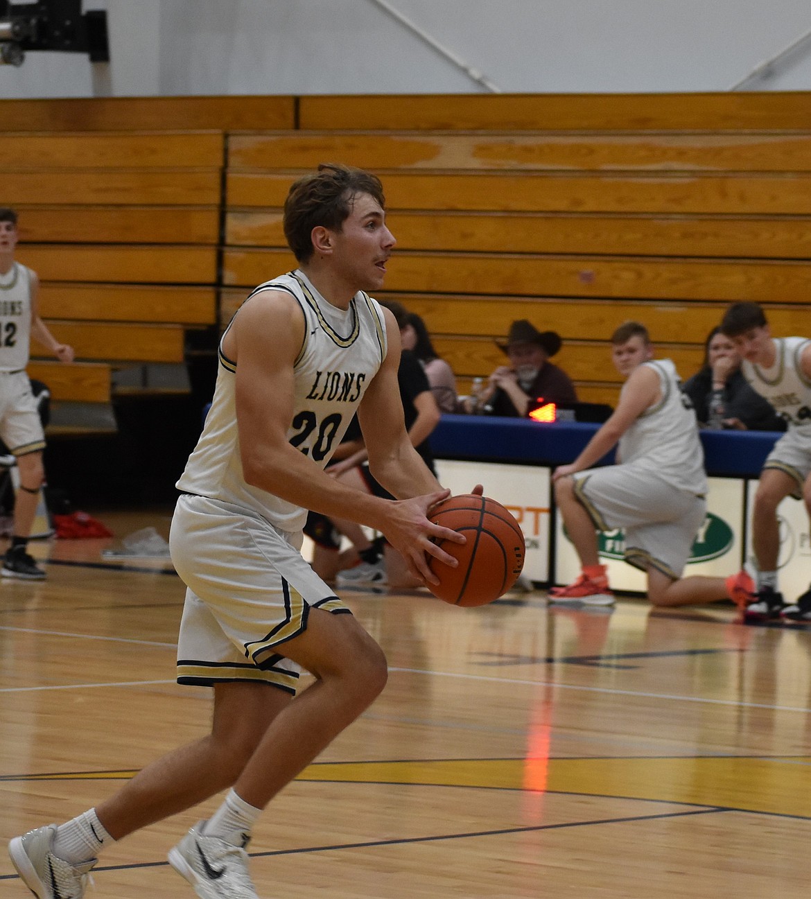 Lions junior Max Gulenko runs up to the hoop and makes a dunk during Monday’s game against Waitsburg. Gulenko said the team finds success when it plays strong and fast from the very beginning.