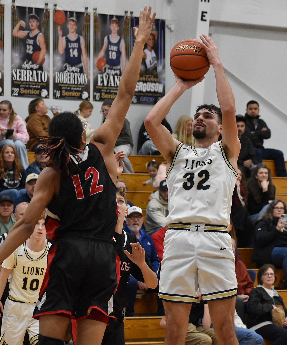 Lions senior Dennis Gulenko shoots for two with pressure from Waitsburg during the final quarter on Monday.