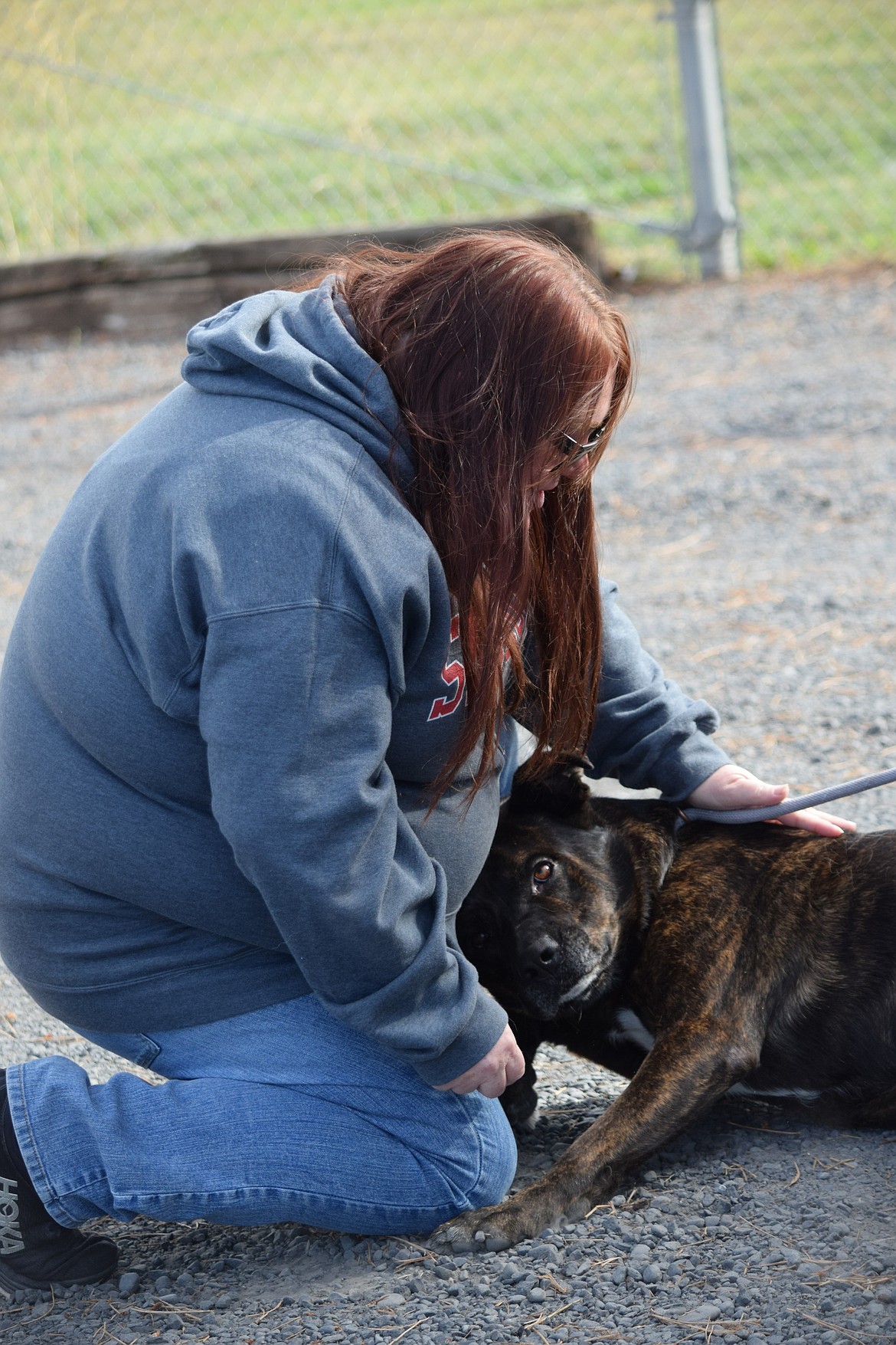 Grant County Animal Outreach Manager Cyndle Miller pets Zeus, one of the dogs in the care of the shelter. According to staff, Zeus has come a long way from initially arriving at the shelter in Nov. 2022. Instead of an angry, non-trusting pooch, he is friendly and loves bonding with children.