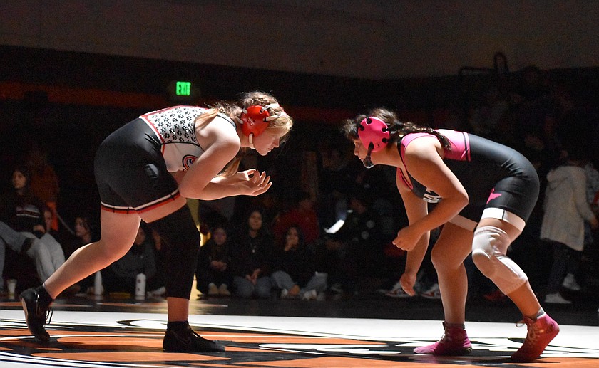 Lucy Gilbert from the Huskies, left, faces off against Gabbie Grace Bafus from the Tigers, right in the 170-lb match Tuesday evening.