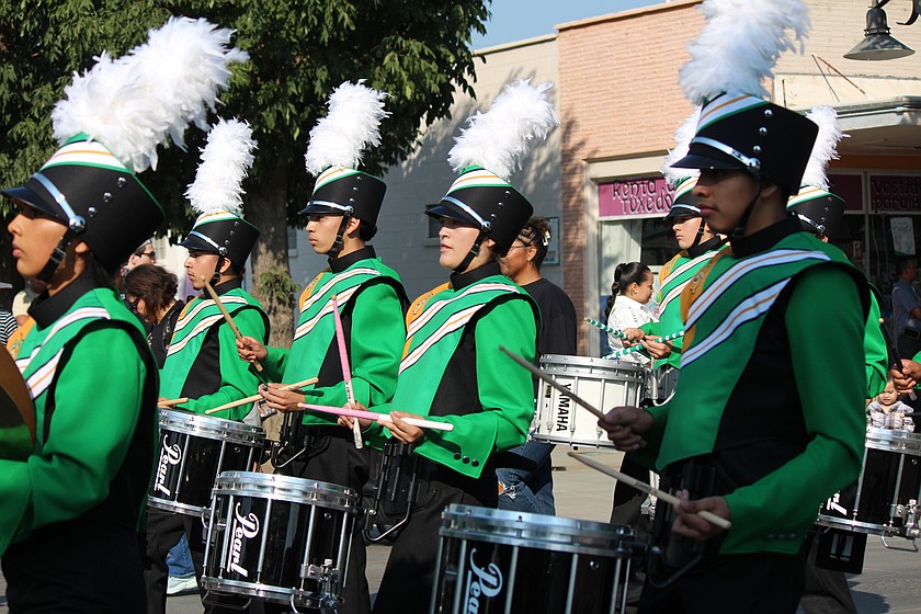 Quincy High School band members march down the street during the 2025 Farmer-Consumer Awareness Day parade. Quincy is one of the schools with an educational programs and operations levy on the February ballot, and the levy helps pay some of the music program expenses.