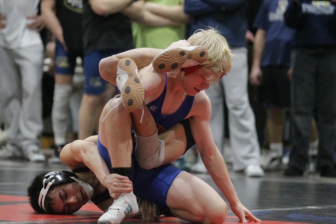 JASON ELLIOTT/Press
Coeur d'Alene wrestler Rocco White attempts to get off the mat in his match against Mead's Breydon Nguyen during their match at 113 pounds at the River City Duals tournament at Post Falls High. White pinned Nguyen in 2:34.