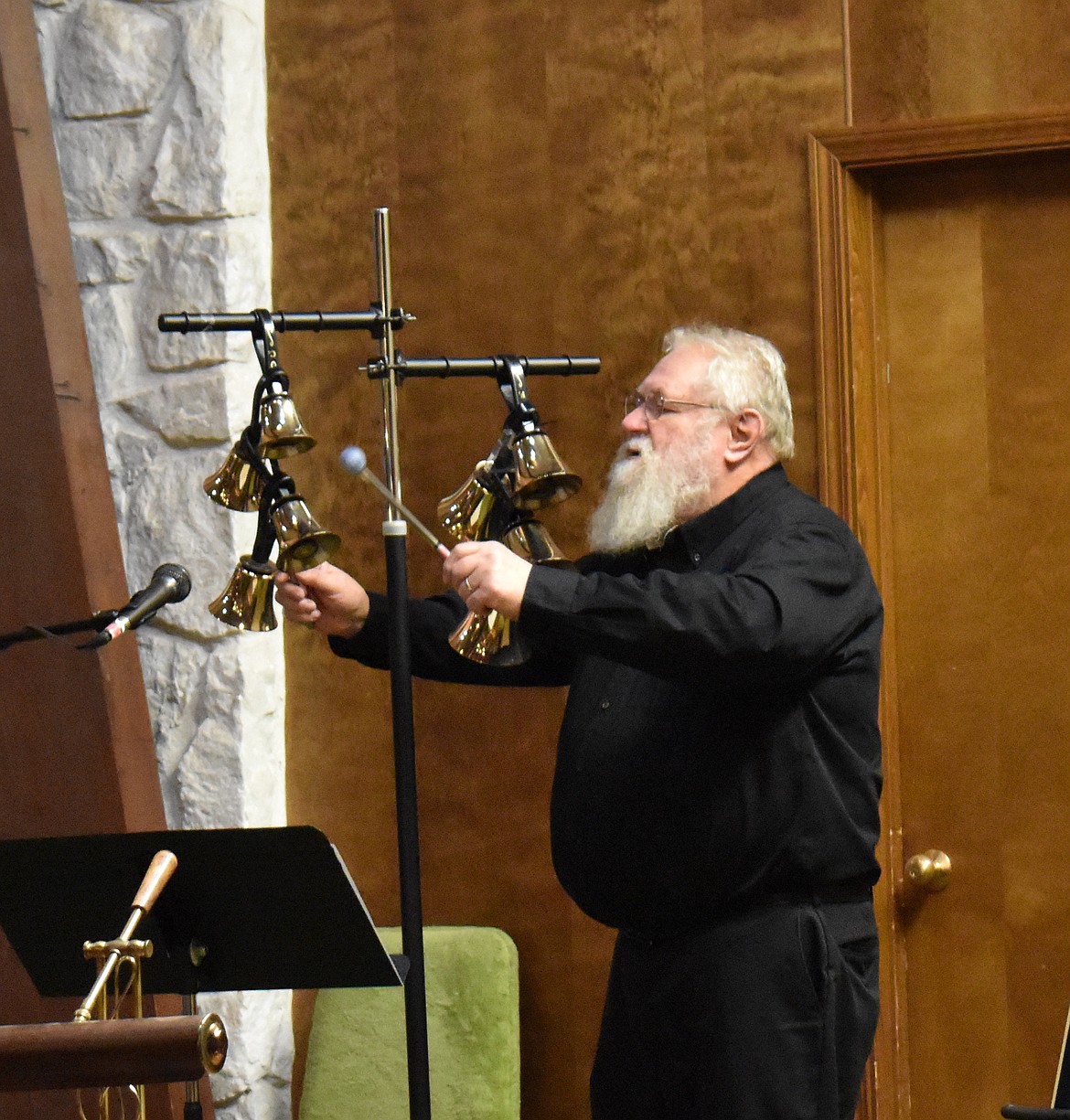 George Roper plays “The First Noel” on the bell tree at Othello Christian Church. The bell tree is the only way a musician can be said to be “playing” the bells, Roper explained; when they perform with handbells, they’re ringing,  not playing.