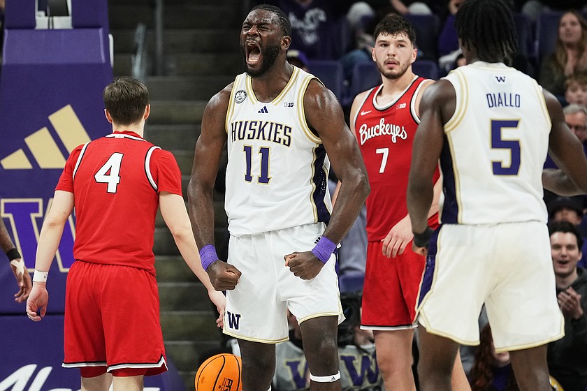 Washington center Franck Kepnang (11) reacts to a foul by Ohio State during the second half of an NCAA college basketball game Sunday, Jan. 11, 2026, in Seattle.