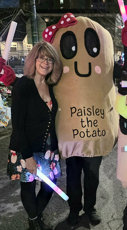 Children's book author Rhonda Newton is pictured with Paisely the Potato, played by B’Shaun Taylor.