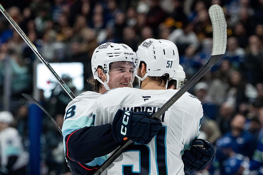 Seattle Kraken's Cale Fleury (8) celebrates after his goal against the Vancouver Canucks with teammate Shane Wright (51) during the first period of an NHL game in Vancouver, British Columbia, Friday, Jan. 2, 2026.