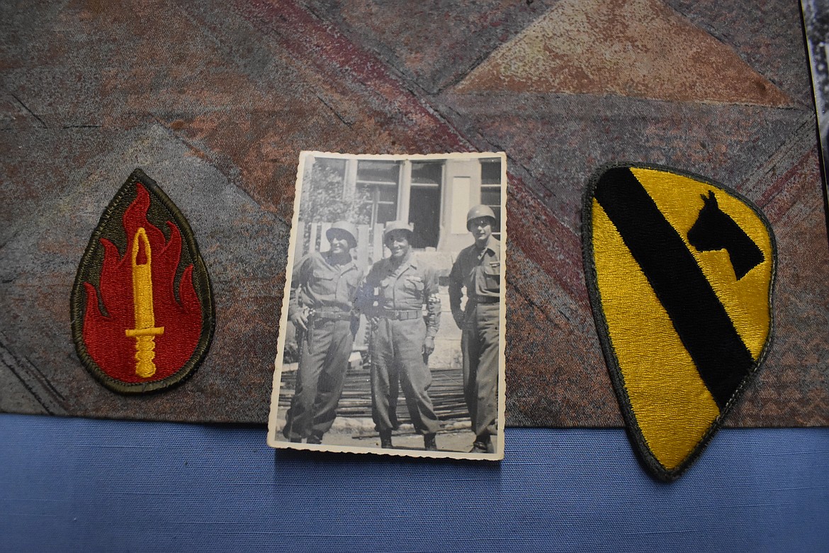 The patch of the 63rd Infantry Division, the “Blood and Fire” Division from World War II, the original photo of Tony Bennett, left, and Herbert Black, middle, during the war and Herbert Black’s 1st Cavalry Division Patch from his service in Vietnam.