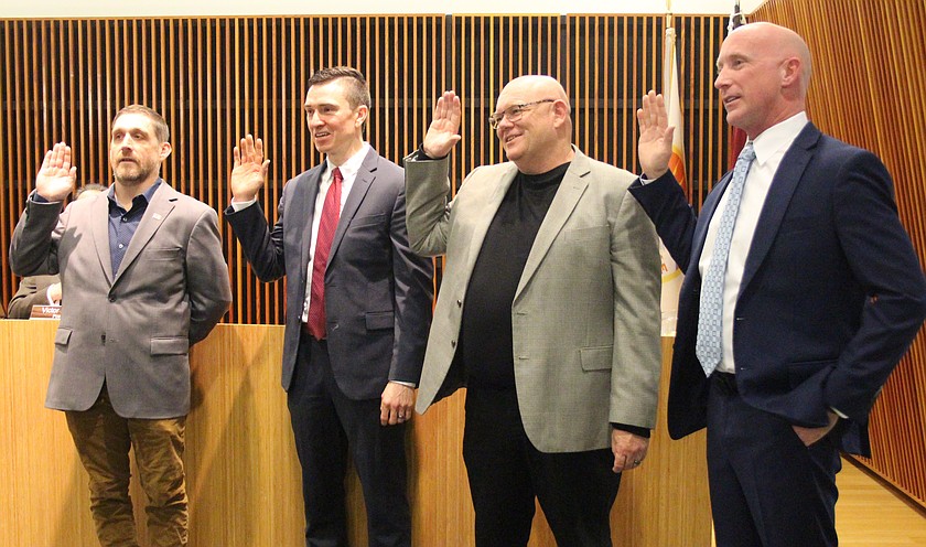 From left, Moses Lake Mayor Dustin Swartz and Moses Lake City Council members Joel Graves, Mark Fancher and Jeremy Davis take the oath of office during Tuesday’s council meeting.