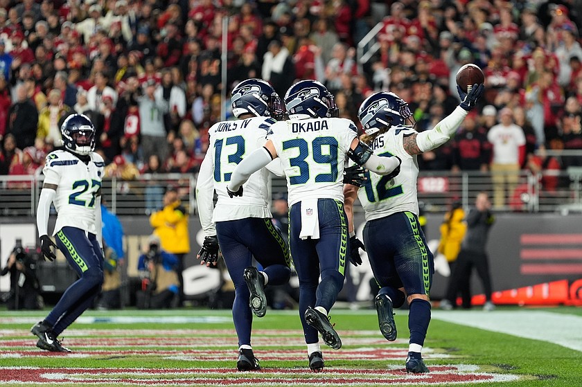 Seattle Seahawks linebacker Drake Thomas, right, is congratulated by safety Ty Okada (39) and linebacker Ernest Jones IV (13) after intercepting a pass against the San Francisco 49ers during the second half of an NFL football game in Santa Clara, Calif., Saturday, Jan. 3, 2026.
