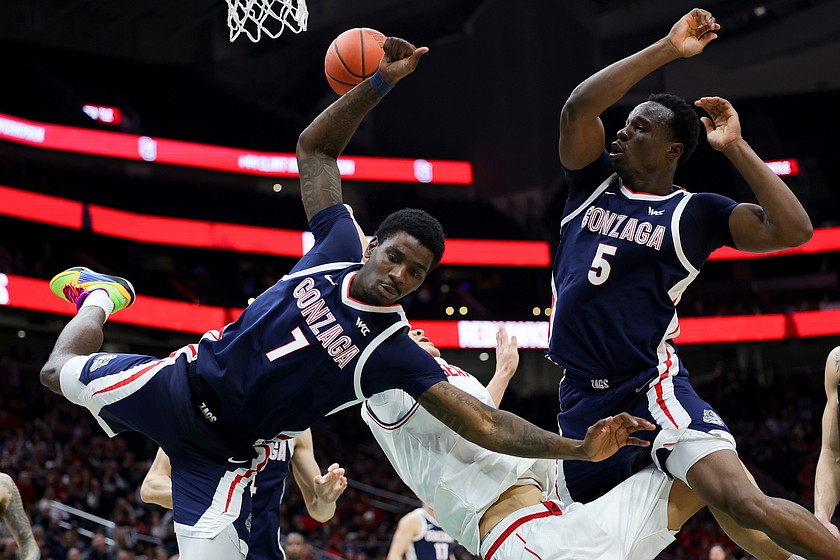 Gonzaga guard Tyon Grant-Foster, left, and forward Emmanuel Innocenti, right, collide with Seattle University center Houran Dan, center, during the second half of an NCAA college basketball game Saturday, Jan. 17, 2026, in Seattle.