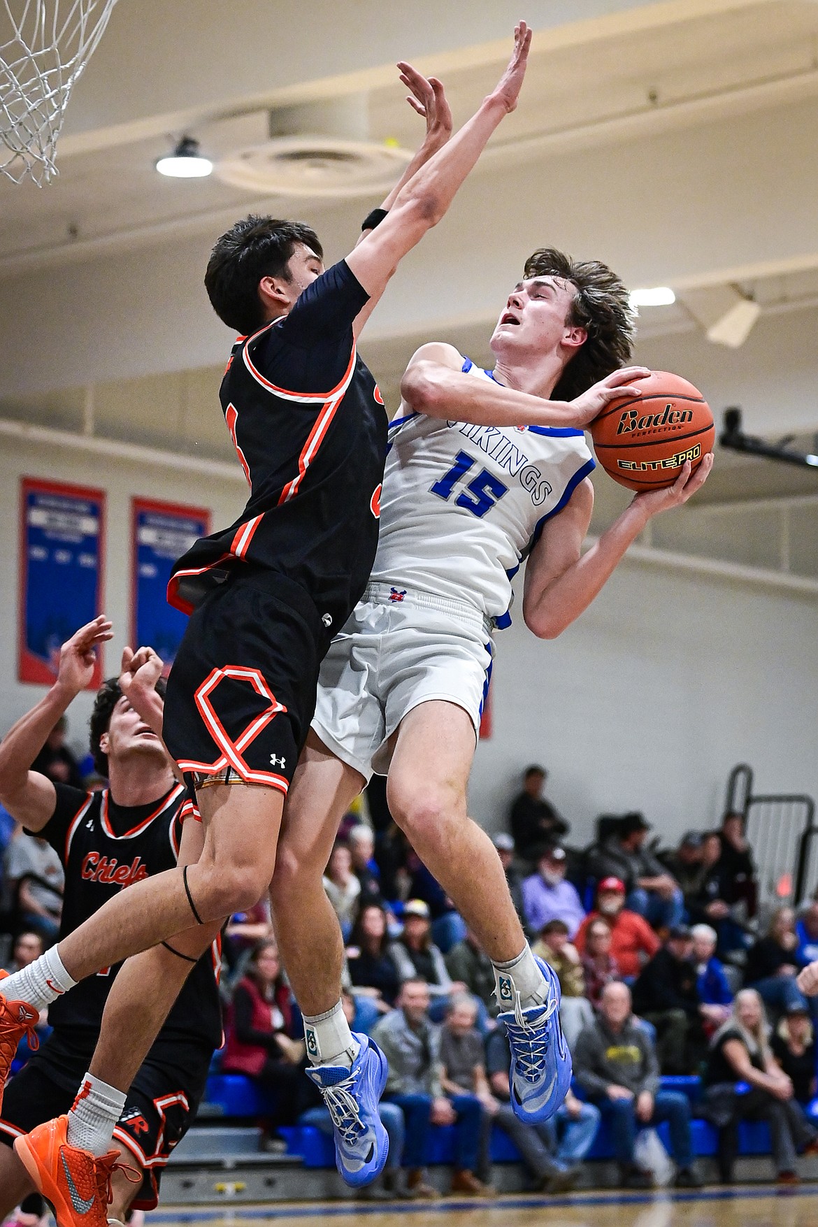 Bigfork's Austin Savik (15) gets a contested layup to fall in the first half against Ronan at Bigfork High School on Tuesday, Jan. 20. (Casey Kreider/Daily Inter Lake)
