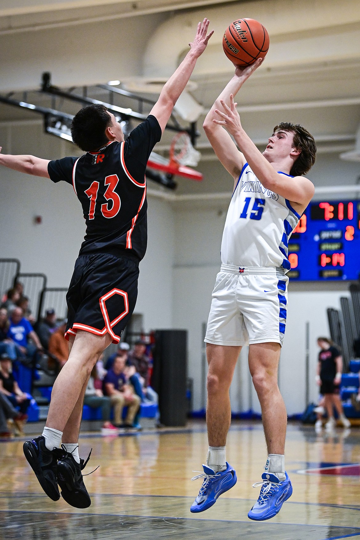 Bigfork's Austin Savik (15) shoots guarded by Ronan's Tryance Matt (13) in the first half at Bigfork High School on Tuesday, Jan. 20. (Casey Kreider/Daily Inter Lake)