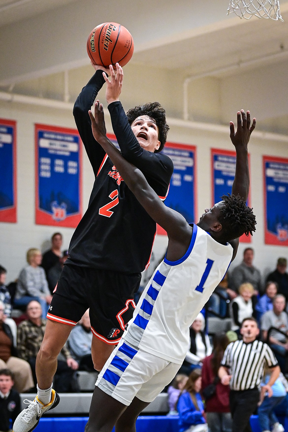 Ronan's Siouxpixm Qualtier (2) drives to the basket guarded by Bigfork's Tamret Savik (1) in the second half at Bigfork High School on Tuesday, Jan. 20. (Casey Kreider/Daily Inter Lake)