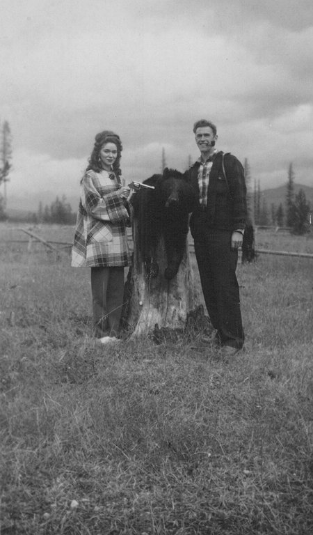Dan_and_Gerane_with_the_bear_on_a_stump.