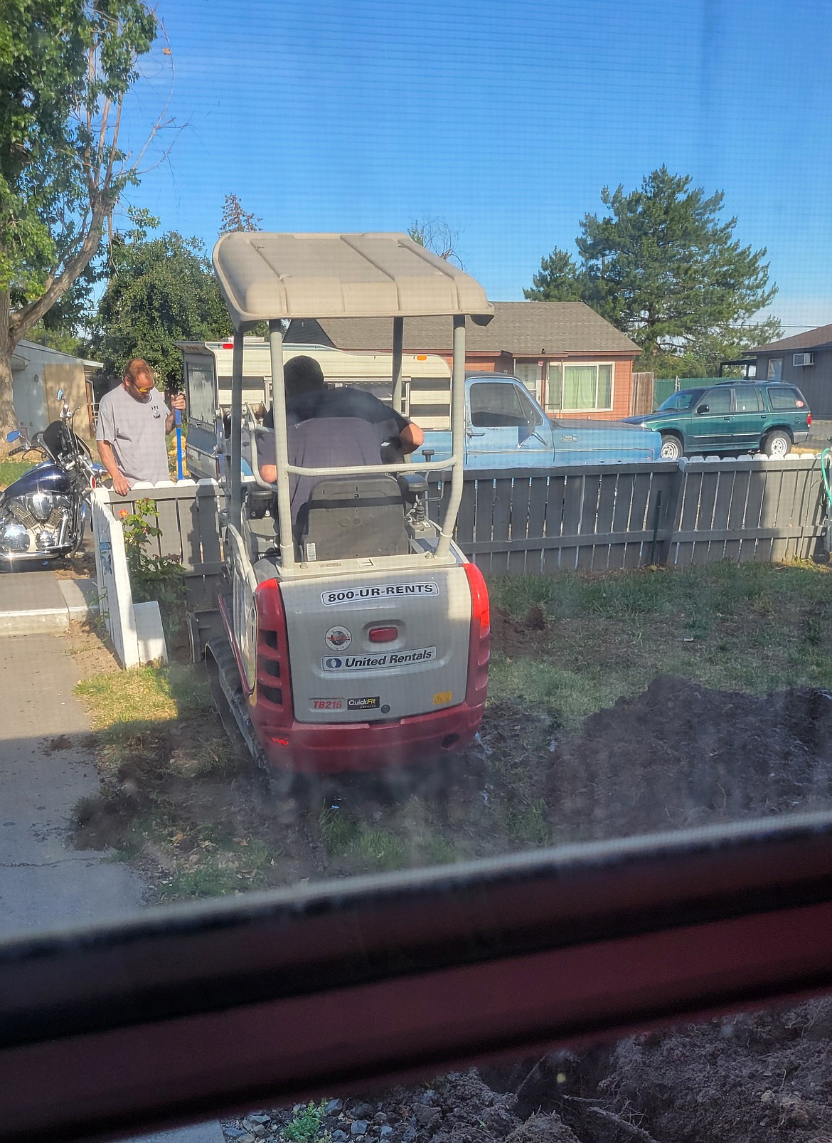Workers from ABS Plumbing repair a water main for Cheryl Lalkus of Moses Lake. The work would have cost her $6,500 that she didn’t have, Lalkus said, but Habitat for Humanity was able to help her cover it.
