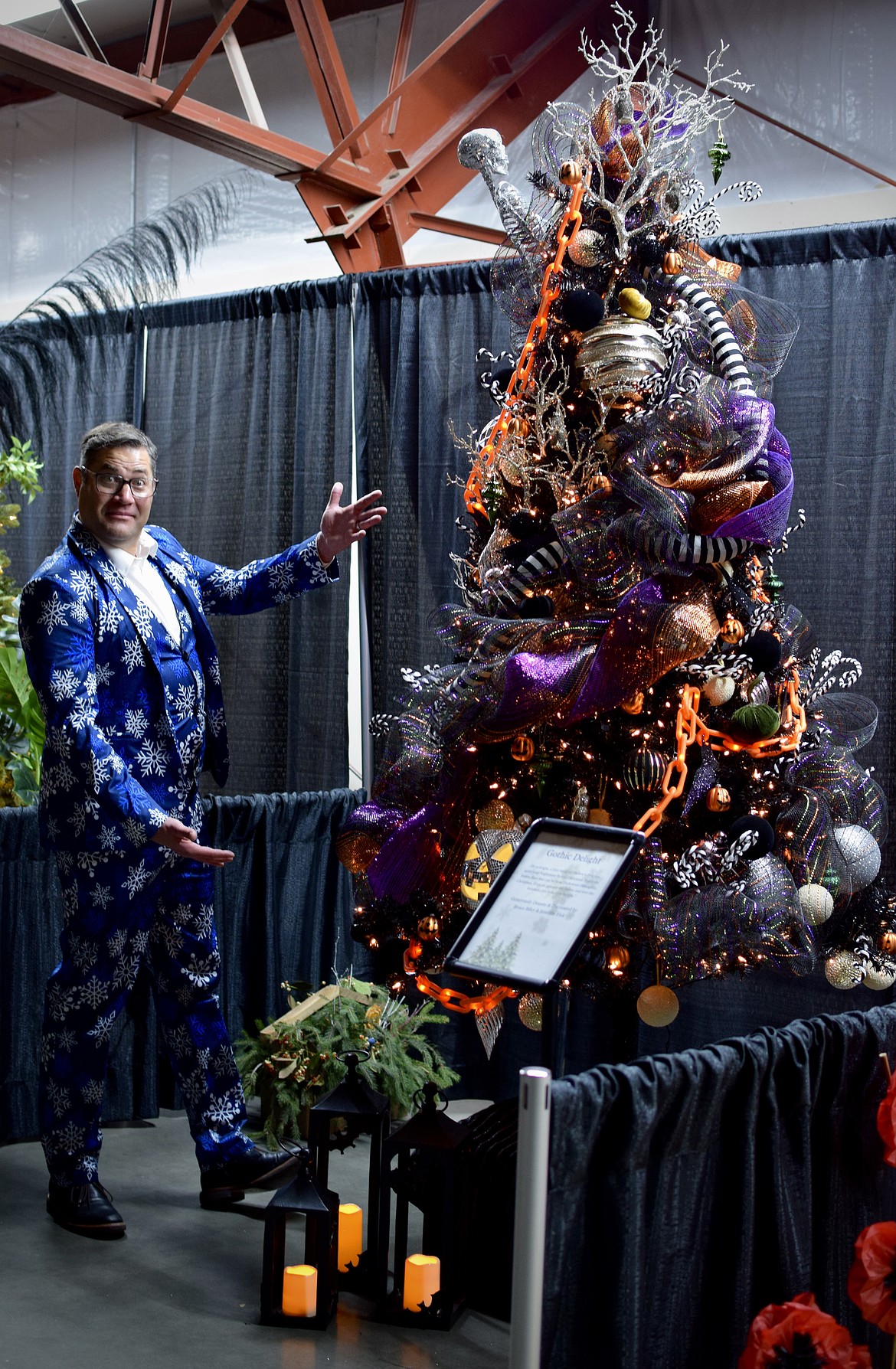 Robin Moore looks over a decorated Christmas tree at Habitat for Humanity of Greater Moses Lake’s Festival of Trees in December. The event raised about $80,000 that will go toward home repairs in 2026.