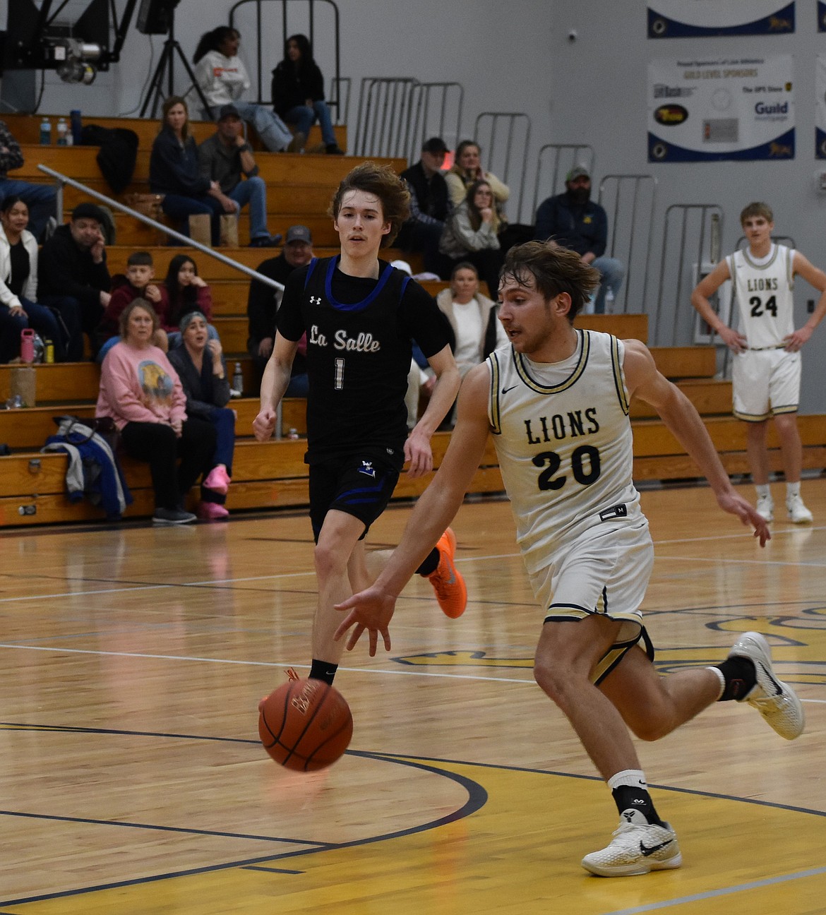 Lions junior Max Gulenko breaks away from the crowd as he prepares to dunk the ball in the final seconds of the game.