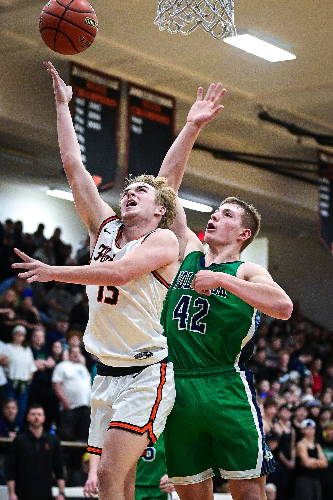 Flathead's Hunter Fann (15) drives to the basket guarded by Glacier's Carter Knopik (42) in the second half at Flathead High School on Friday, Jan. 23. (Casey Kreider/Daily Inter Lake)
