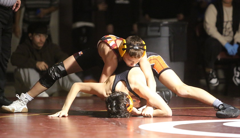 The Mavs’ Darien Prescott, on top, controls his opponent on the mat after earning a takedown. The Mavericks defeated Davis 47-24 Thursday in their final home duel of the season.