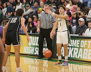 Pierce Bierlink (1) directs traffic on offense as Brady Hendrick (12) steps up to guard him. Quincy defeated Ephrata 72-39 Friday to keep their postseason hopes alive.