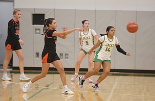 The Tigers’ Hannah Malone (5) passes the ball to a teammate as Jenevy Gudino (14) plays close defense. The Jacks defeated the Tigers 59-32 Friday.
