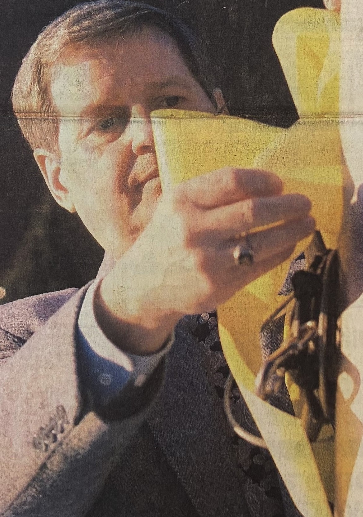 Superintendent Keith Tolzin ties a yellow ribbon around the flagpole at the Coeur d’Alene School District office in 1991.