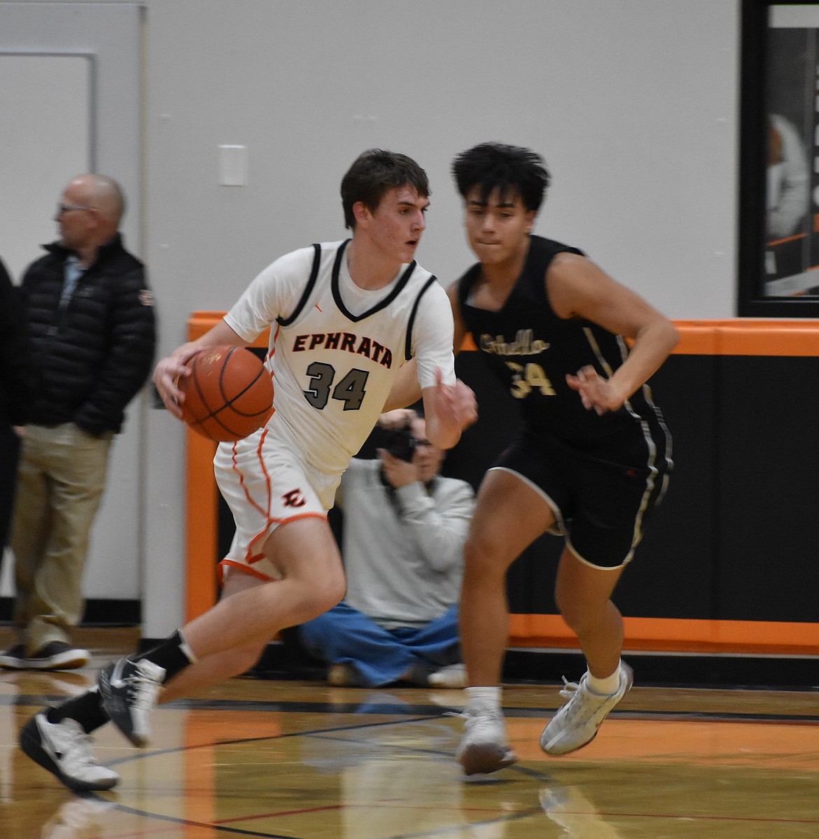 Tigers junior Benson Bair, left, works to get around Huskies senior Luis Farias Villanueva, right.
