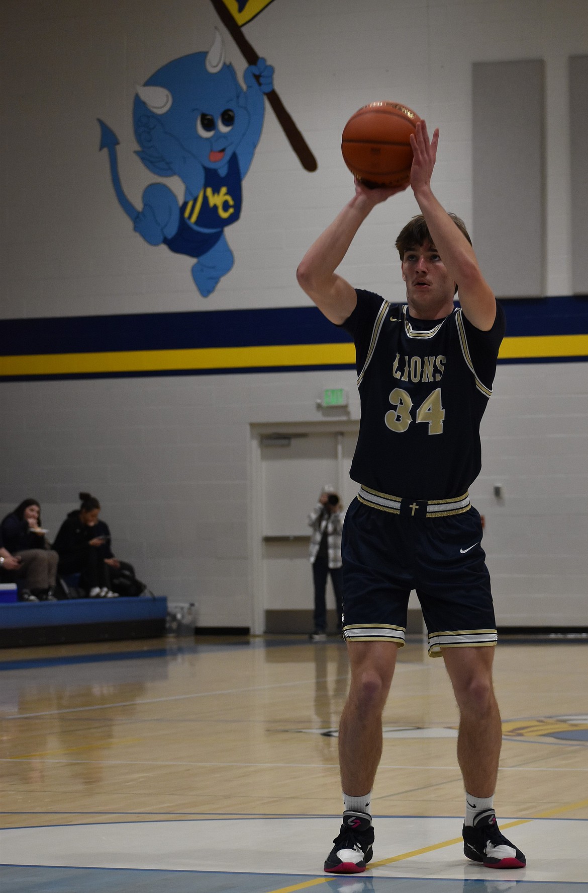 Lions junior Kevin Jorgenson aims for the hoop during a free throw against Wilson Creek.