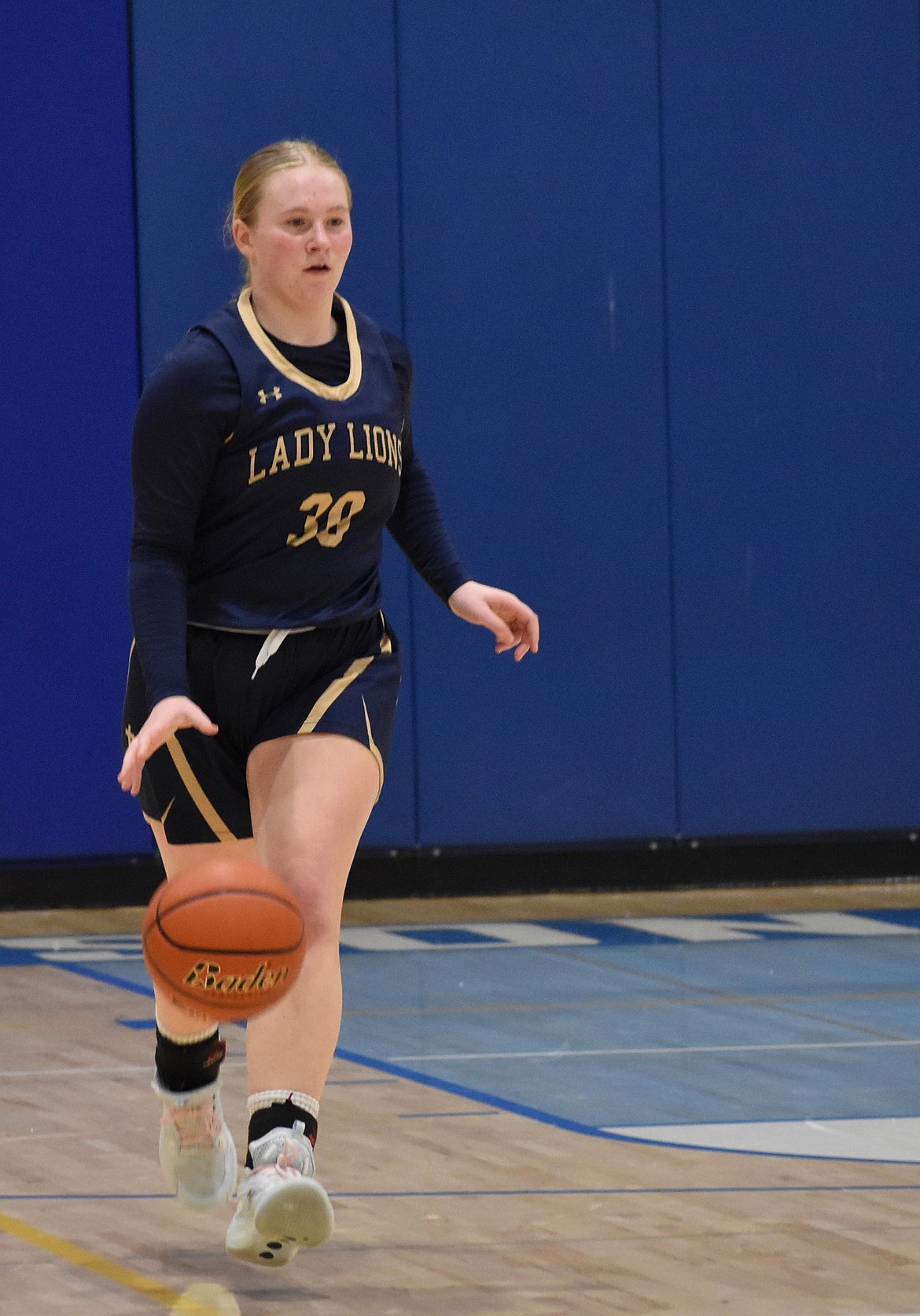 Abby Stanley, a junior from the Lions, makes her way down the court after gaining possession of the ball.