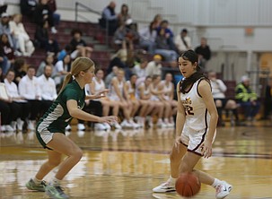 The Mavericks’ Reese Char (22) dribbles the ball around a Ridgeline defender earlier this season.