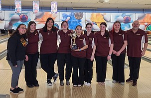 The Mavericks bowling team celebrates their league title trophy after the district competition Friday. From left: Assistant Coach Victoria Weber, Jenna Zenke, Odalys Santos Martinez, Annmarie Kagele, Abby Vasquez, Lizzy Cochrun, Jayla Pierce, Allie Biles and Head Coach Dan Stevenson.