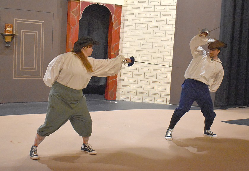 Kristina Allman, left, and Blane Schafer cross swords in “The Complete Works of William Shakespeare (abridged) [revised] [again],” opening Feb. 13 at the Masquers Theater.