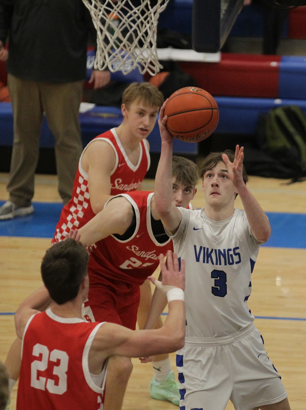MARK NELKE/Press
Coeur d'Alene junior Rylan Braga (3) goes up for a shot as Caiden Gion (23) and Logan Roos of Sandpoint defend on Thursday night at Coeur d'Alene High.