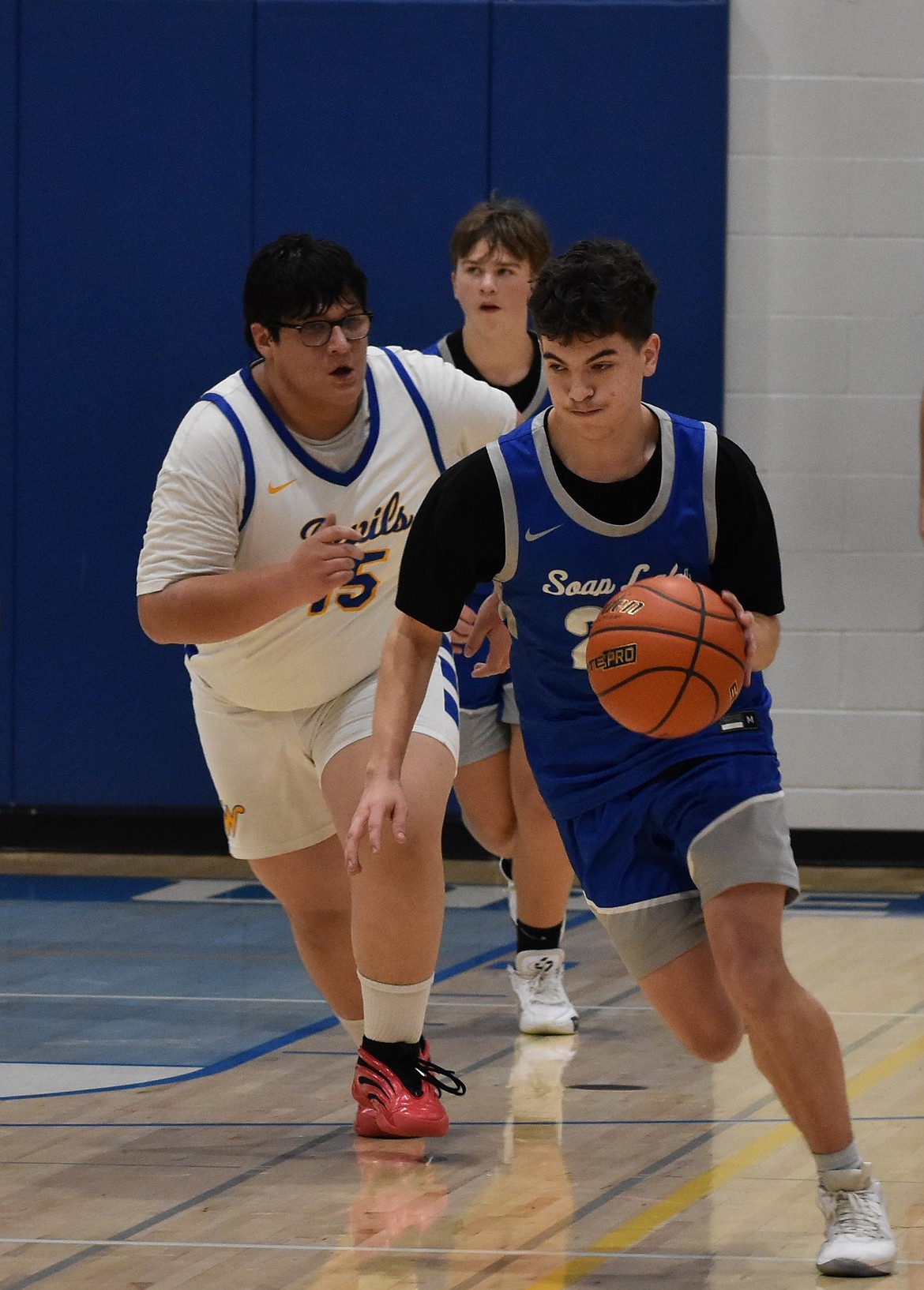 Xavier Ewing, a senior from the Eagles, rushes past Isaias Alvarez, a senior from the Devils during Thursday’s senior night at Wilson Creek.