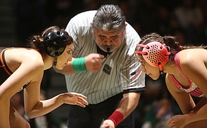 Addison Vasquez, left, and Hailey Courtade, right, face off in the Battle of the Basin wrestling dual. The Ephrata Tigers defeated the Quincy Jacks 38-36 Thursday.