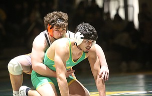 Peyton Woods, in orange, prepares to prevent Alejandro Barajas, in green, from escaping his hold during their match. The Ephrata Tigers defeated the Quincy Jacks 37-28 Thursday to conclude the regular season.